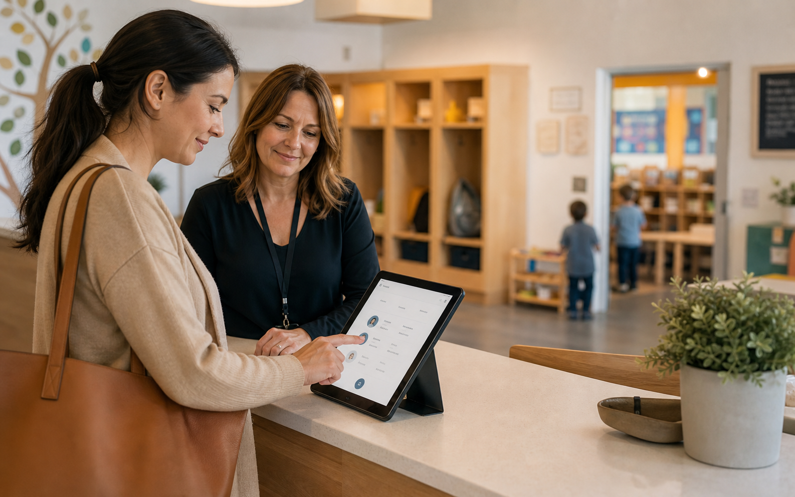 A parent and school director using The BEE Suite at a childcare front desk